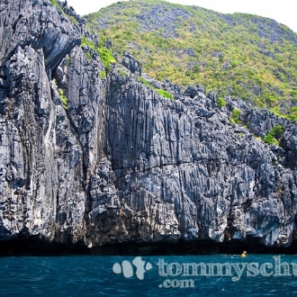 Palawan karst limestone cliff and blue water of the South China