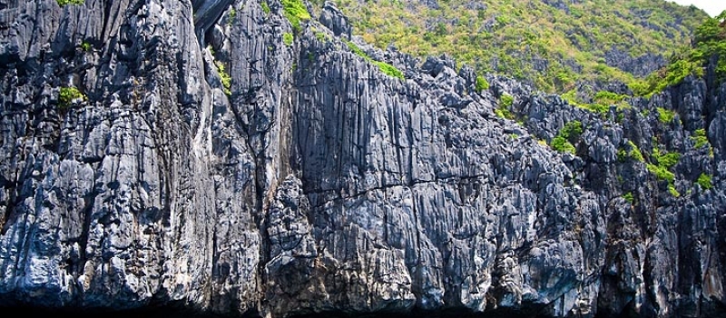 Palawan karst limestone cliff and blue water of the South China