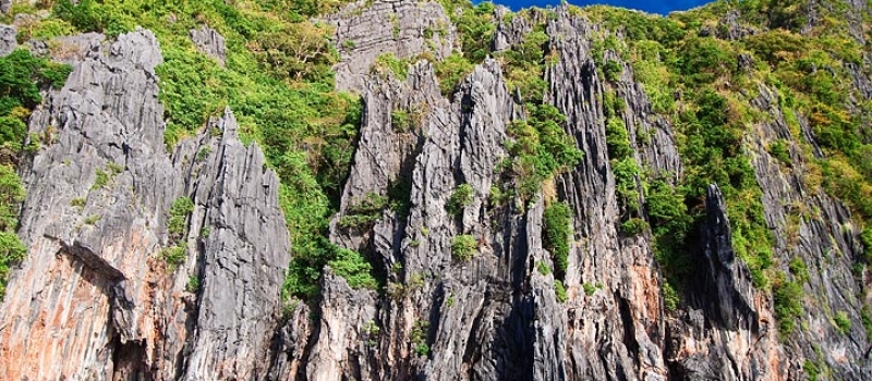 Jagged karst limestone cliff and the South China Sea in Palawan